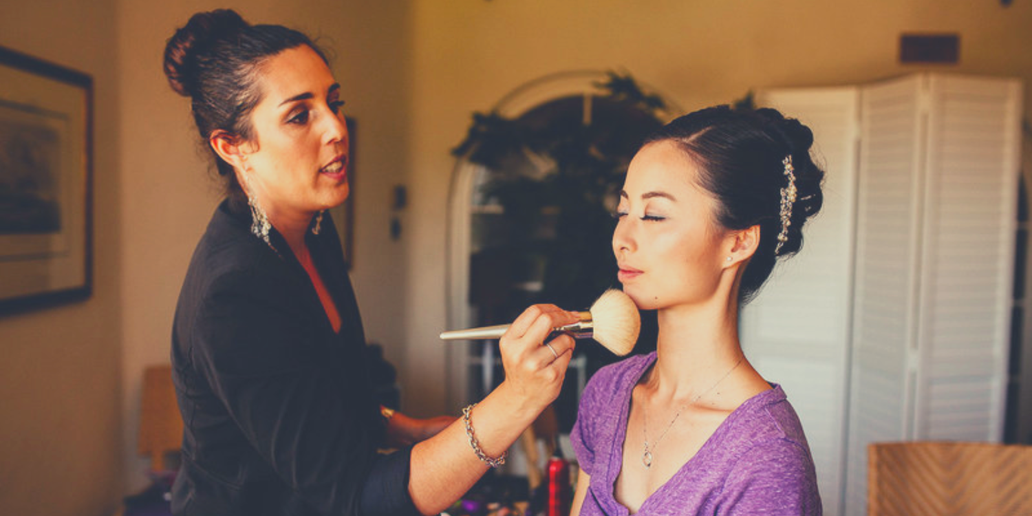 Image of Natalie Setareh (makeup artist) applying makeup on an Asian woman.