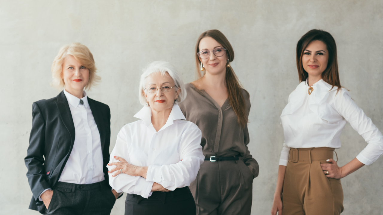Image of women in a professional attire confidently posing for the camera